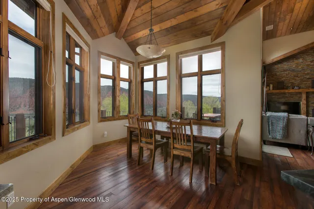 a dining room with furniture window and wooden floor