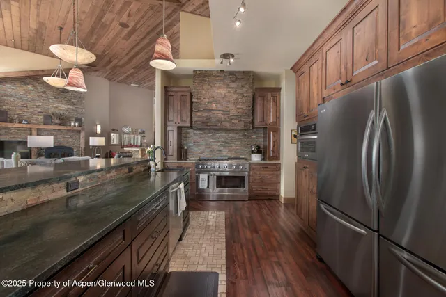 a kitchen with stainless steel appliances a refrigerator a stove and a sink