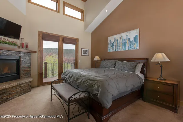 a bedroom with a bed and a fireplace