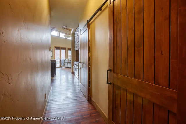 a bedroom with a large bed and a chandelier fan