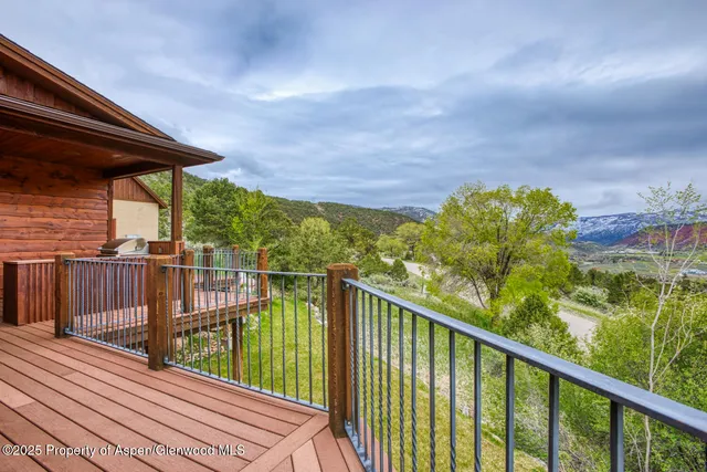 a view of a two chairs and table in the balcony