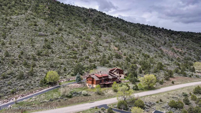an aerial view of a house with a yard lake view and mountain view