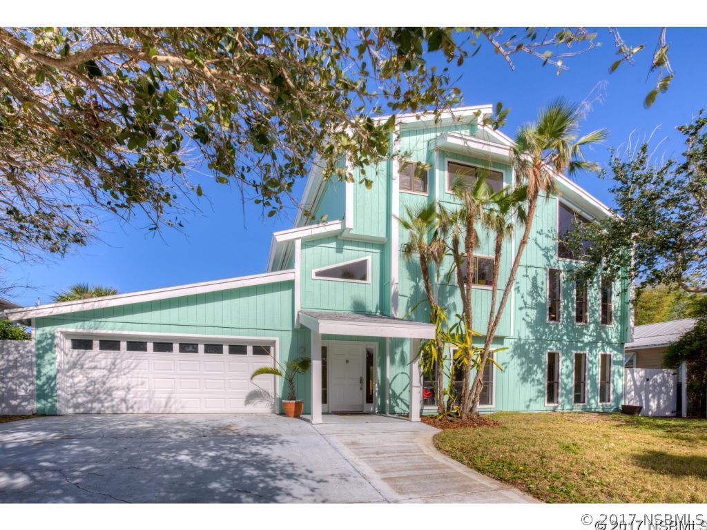 6455 Engram Road New Smyrna Beach, FL 32169 - Photo 1 of 33 a front view of a building with a garden