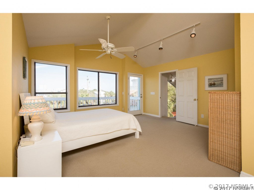6455 Engram Road New Smyrna Beach, FL 32169 - Photo 13 of 33 a bedroom with a bed and a large window