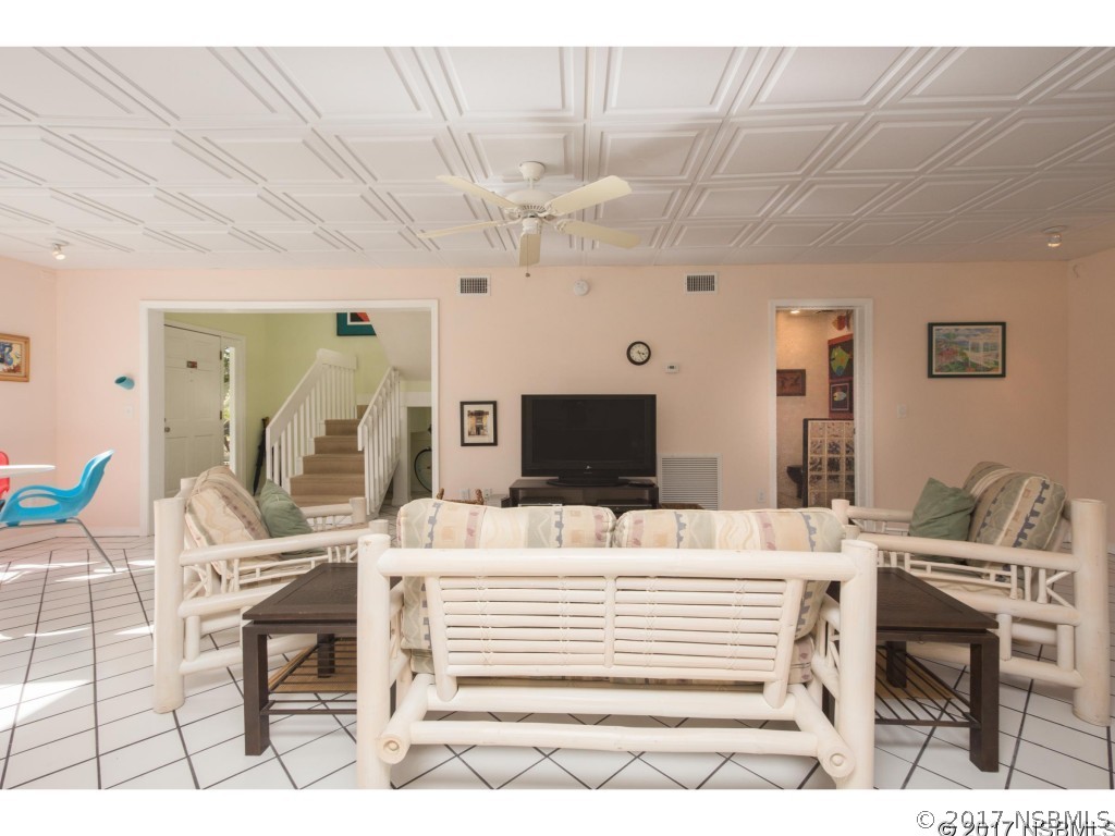 6455 Engram Road New Smyrna Beach, FL 32169 - Photo 15 of 33 a room with furniture and a flat screen tv
