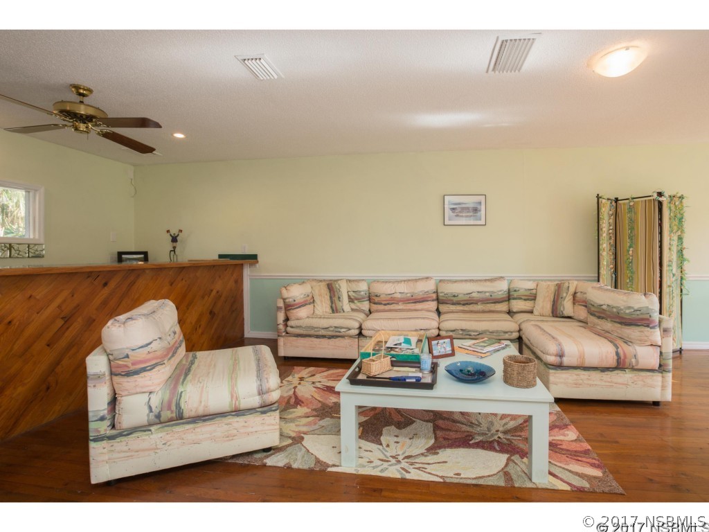 6455 Engram Road New Smyrna Beach, FL 32169 - Photo 16 of 33 a living room with furniture and a rug