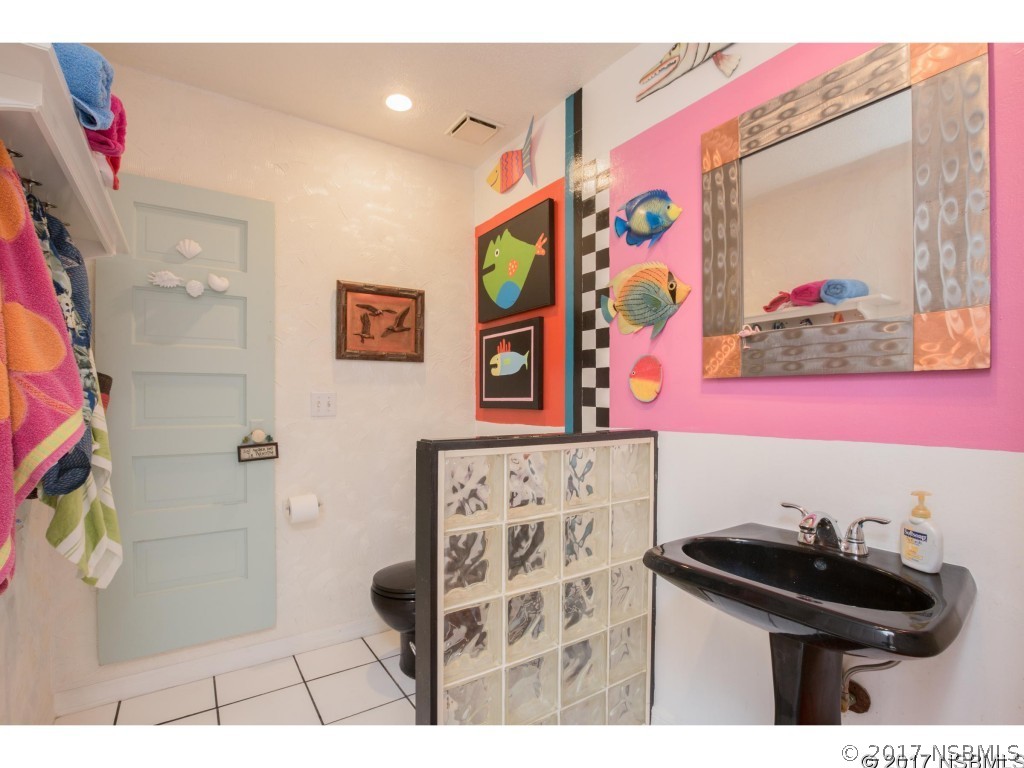 6455 Engram Road New Smyrna Beach, FL 32169 - Photo 18 of 33 a bathroom with a sink a vanity and a toilet