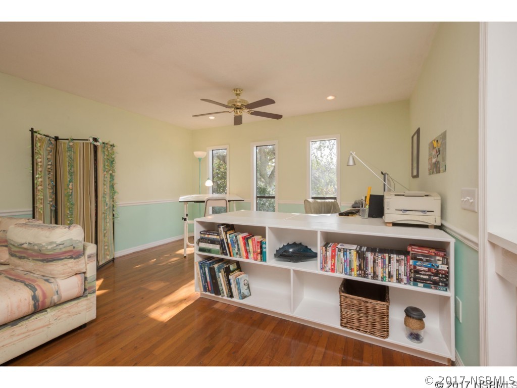 6455 Engram Road New Smyrna Beach, FL 32169 - Photo 19 of 33 a living room with furniture and a book shelf