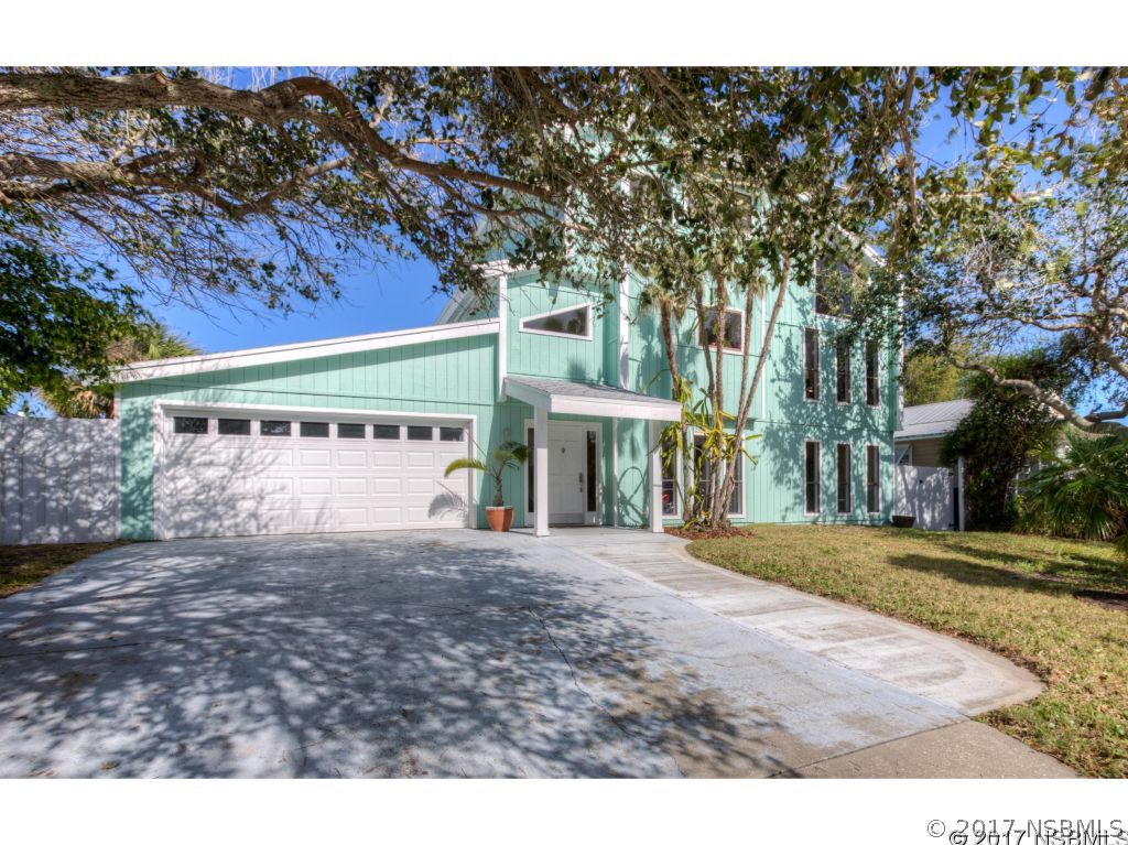 6455 Engram Road New Smyrna Beach, FL 32169 - Photo 2 of 33 a front view of a building with a yard