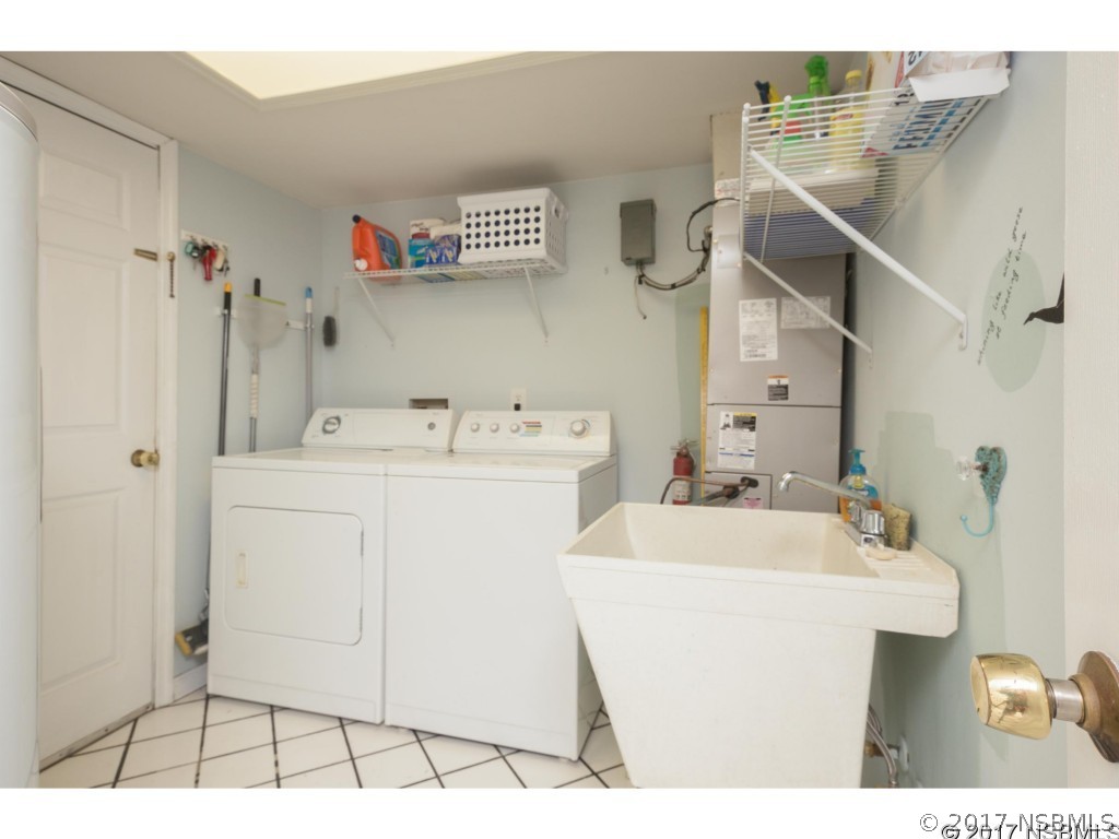 6455 Engram Road New Smyrna Beach, FL 32169 - Photo 22 of 33 a utility room with dryer and washer