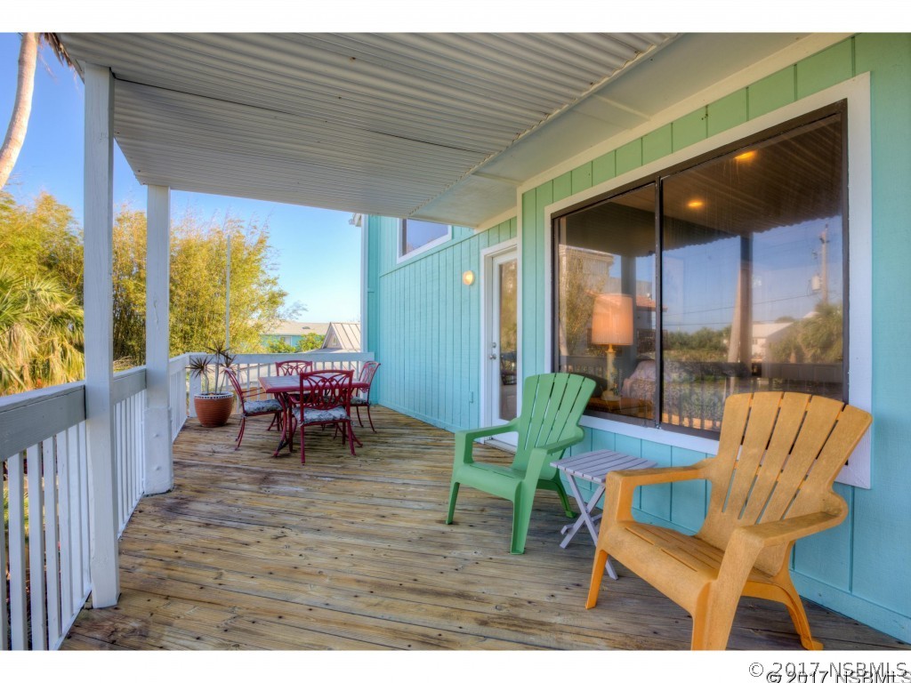 6455 Engram Road New Smyrna Beach, FL 32169 - Photo 28 of 33 a view of a chairs and table in patio with wooden fence