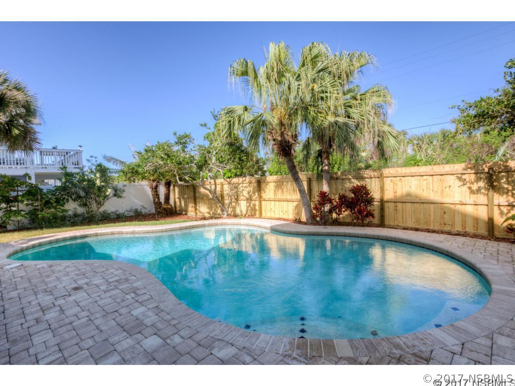 6455 Engram Road New Smyrna Beach, FL 32169 - Photo 29 of 33 a view of a swimming pool and a yard