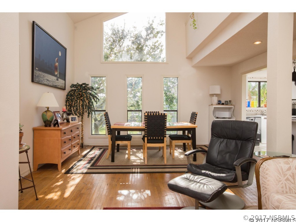 6455 Engram Road New Smyrna Beach, FL 32169 - Photo 5 of 33 a living room with furniture a rug and a flat screen tv