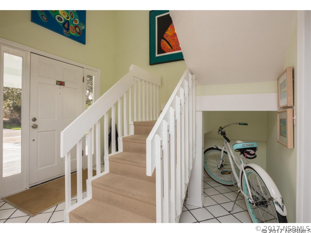 6455 Engram Road New Smyrna Beach, FL 32169 - Photo 8 of 33 a view of a livingroom with wooden floor and stairs