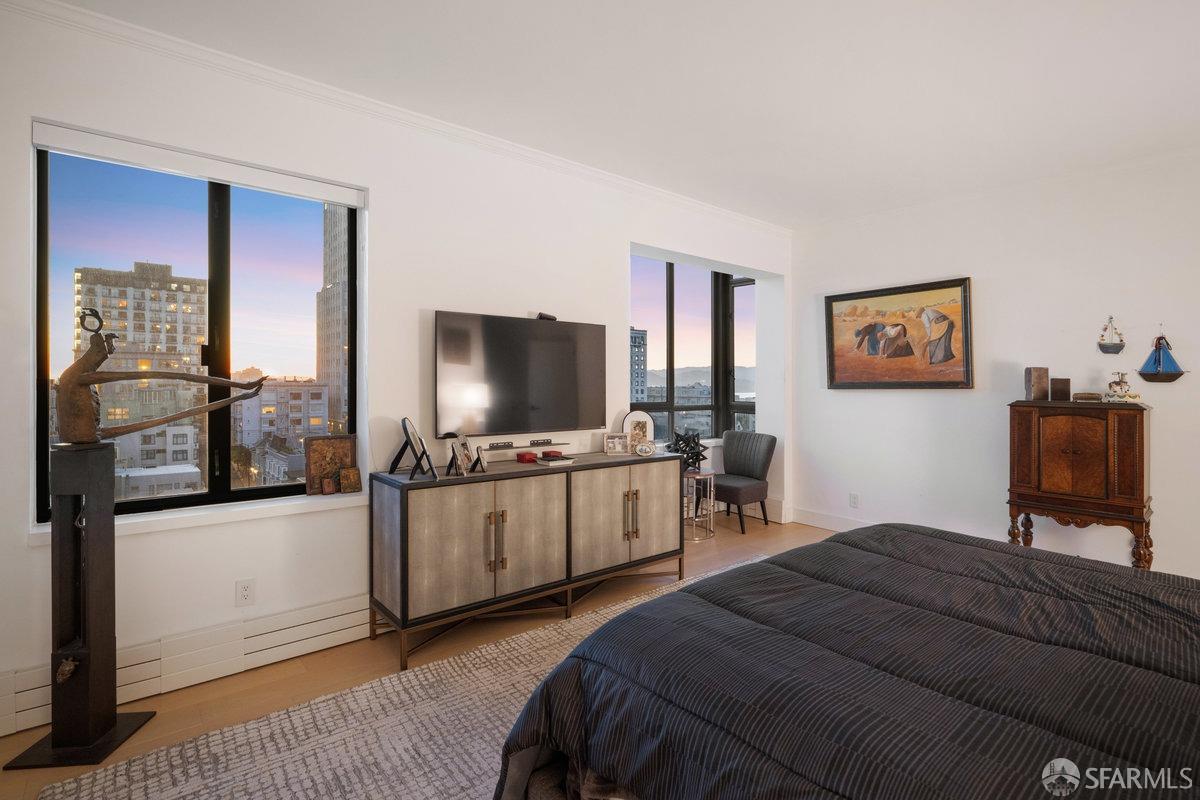 1170 Sacramento Street, Unit 9C San Francisco, CA 94108 - Photo 26 of 32 a bedroom with a bed and a flat screen tv