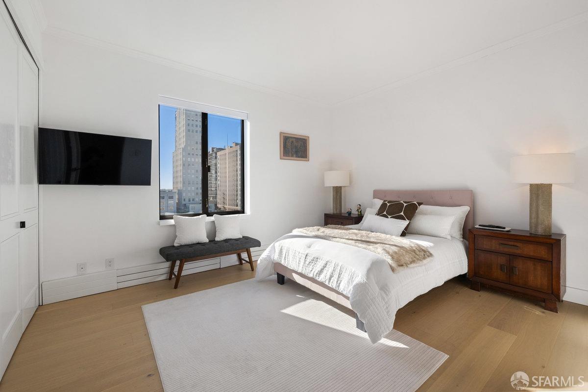 1170 Sacramento Street, Unit 9C San Francisco, CA 94108 - Photo 29 of 32 a bedroom with a bed and a flat screen tv