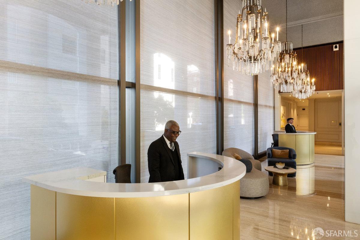 1170 Sacramento Street, Unit 9C San Francisco, CA 94108 - Photo 5 of 32 a kitchen with a sink and chandelier