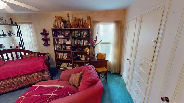 a living room with furniture and a book shelf
