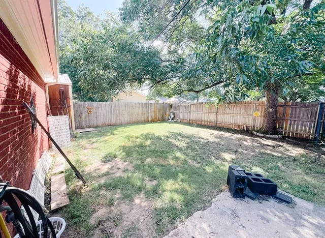 a view of a backyard with a small cabin and a chair