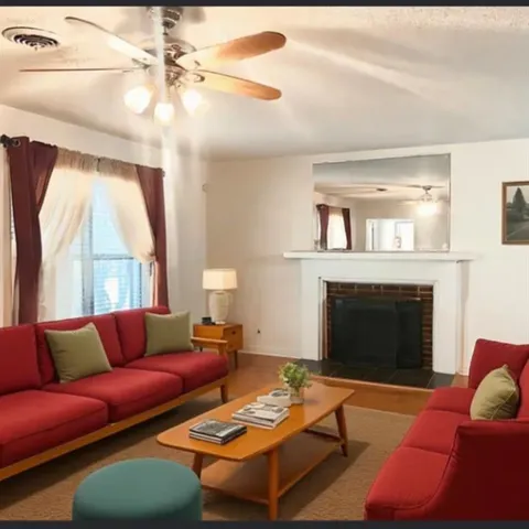 a living room with furniture and a fireplace