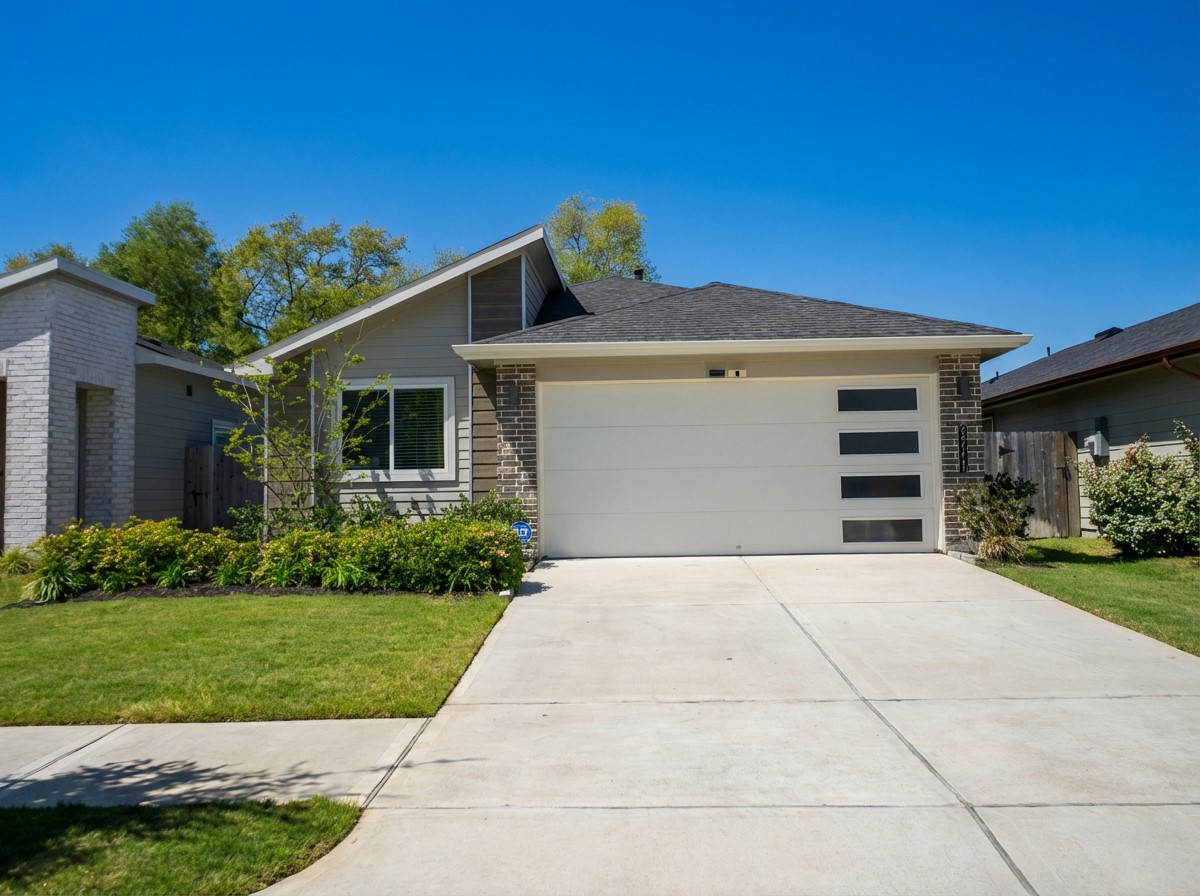 12918 Wempe Way Houston, TX 77047 - Photo 1 of 18 a front view of a house with a yard and garage