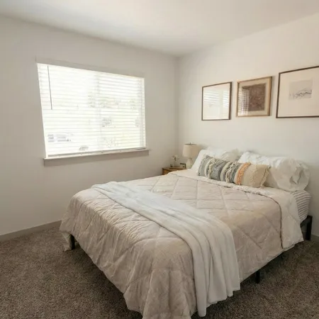 a bedroom with a bed and window