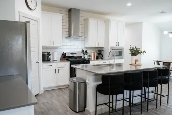 a kitchen with a sink cabinets and refrigerator