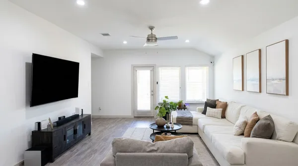 a living room with furniture and a flat screen tv