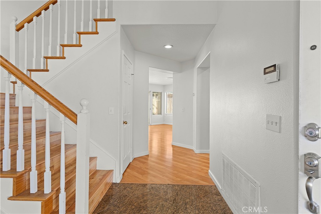 2136 East Colunga Street Colton, CA 92324 - Photo 11 of 40 a view of a hallway with wooden floor and staircase
