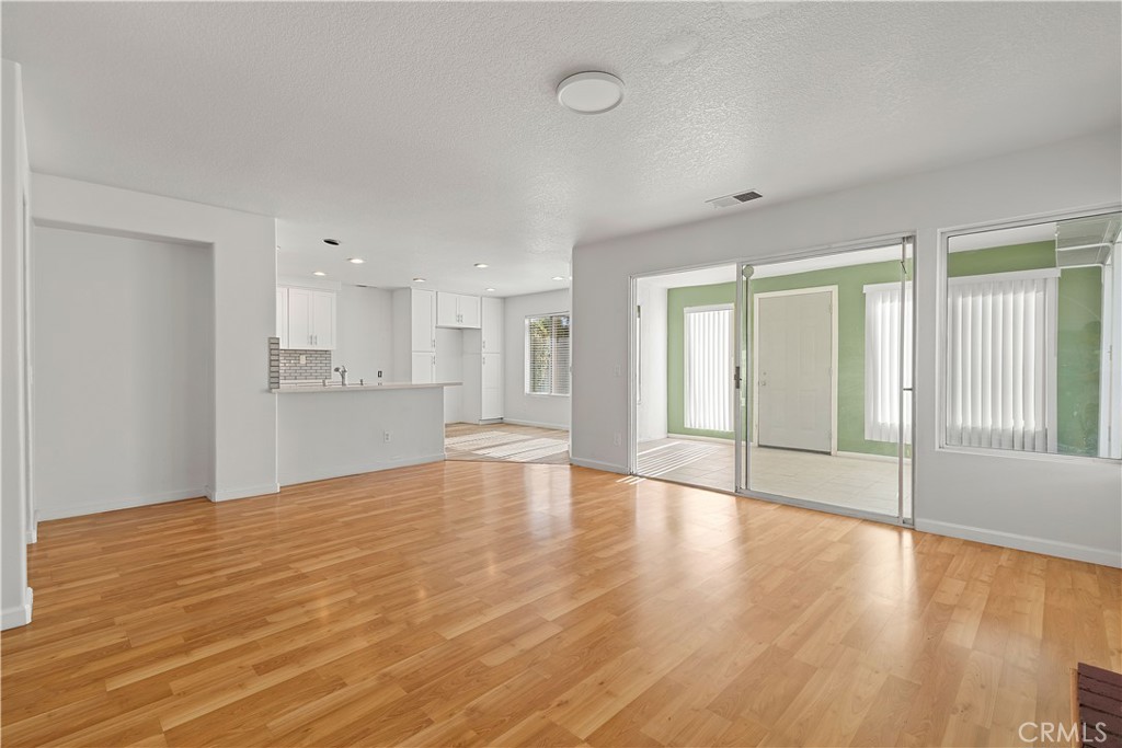 2136 East Colunga Street Colton, CA 92324 - Photo 18 of 40 a view of an empty room with window and wooden floor