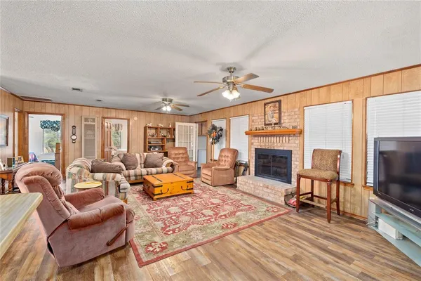 a dining room with stainless steel appliances a dining table and chairs with wooden floor