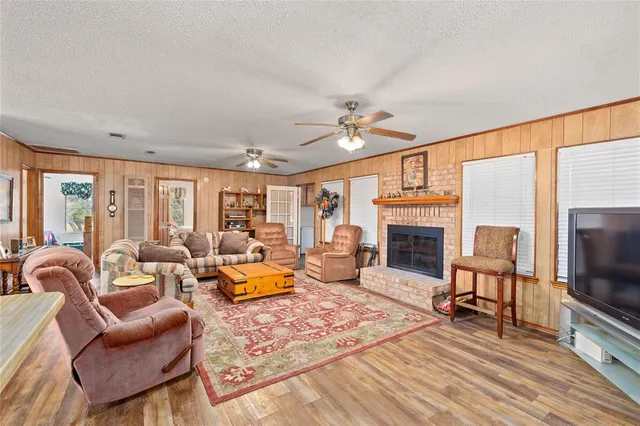 a dining room with stainless steel appliances a dining table and chairs with wooden floor