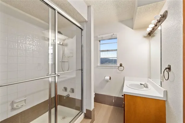 a bathroom with a sink toilet and shower