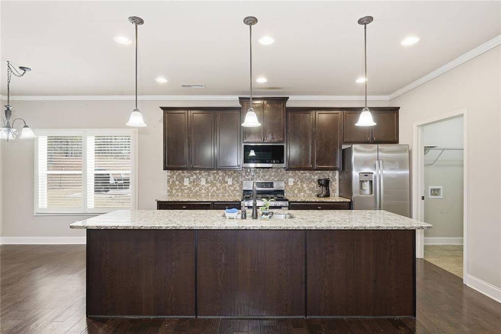 163 Hawthorne Ridge Circle Dallas, GA 30132 - Photo 18 of 50 a kitchen with a refrigerator a sink and oven