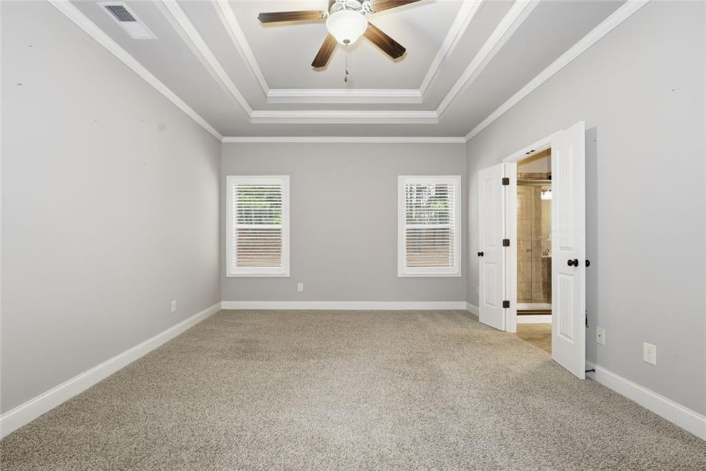 163 Hawthorne Ridge Circle Dallas, GA 30132 - Photo 29 of 50 an empty room with windows and ceiling fan