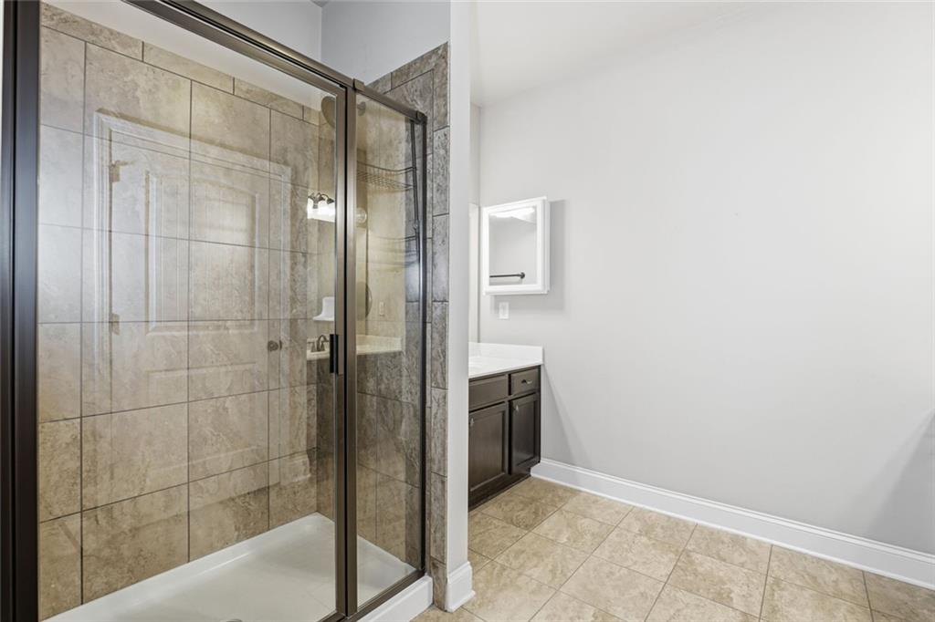 163 Hawthorne Ridge Circle Dallas, GA 30132 - Photo 32 of 50 a bathroom with a shower and a sink