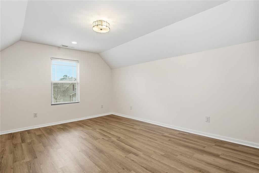 163 Hawthorne Ridge Circle Dallas, GA 30132 - Photo 36 of 50 an empty room with wooden floor and windows