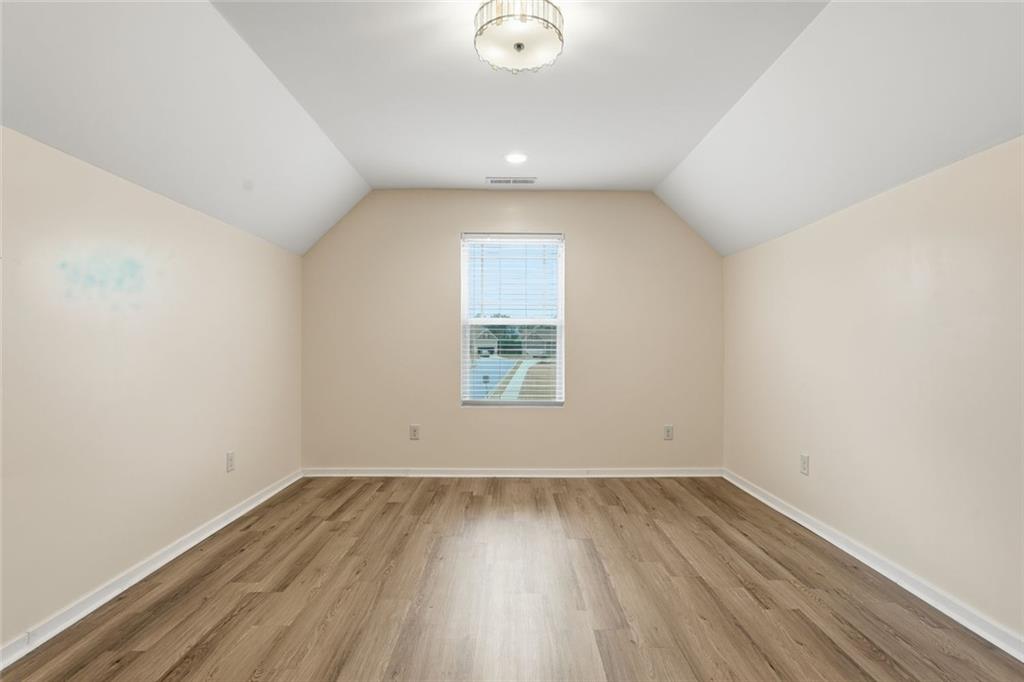 163 Hawthorne Ridge Circle Dallas, GA 30132 - Photo 37 of 50 an empty room with wooden floor and windows
