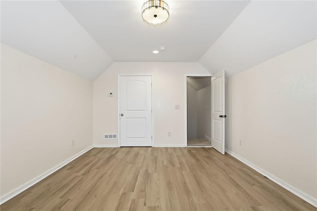 163 Hawthorne Ridge Circle Dallas, GA 30132 - Photo 38 of 50 an empty room with wooden floor and windows