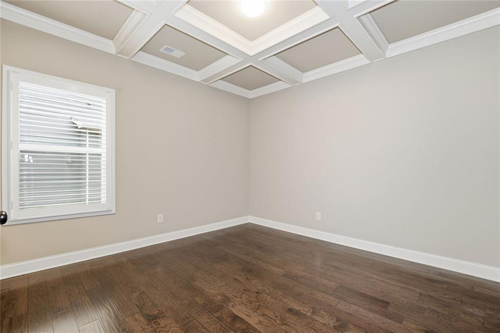 163 Hawthorne Ridge Circle Dallas, GA 30132 - Photo 7 of 50 an empty room with wooden floor and windows
