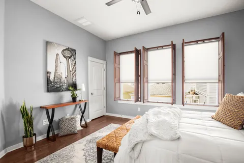 a bedroom with furniture and a large window