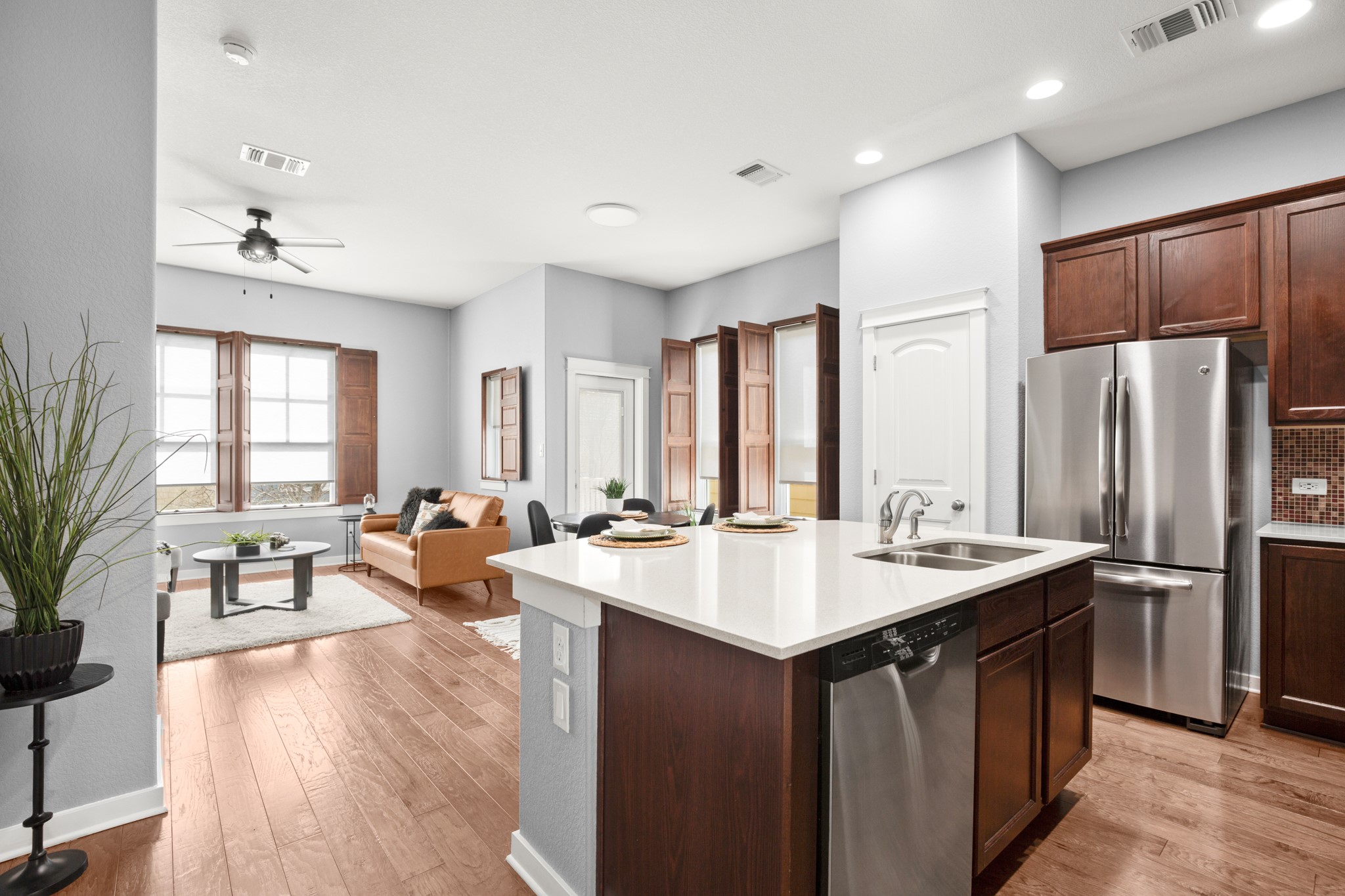 4644 Page Street Austin, TX 78723 - Photo 5 of 21 a living room with stainless steel appliances granite countertop a sink dishwasher a refrigerator and a dining table with wooden floor