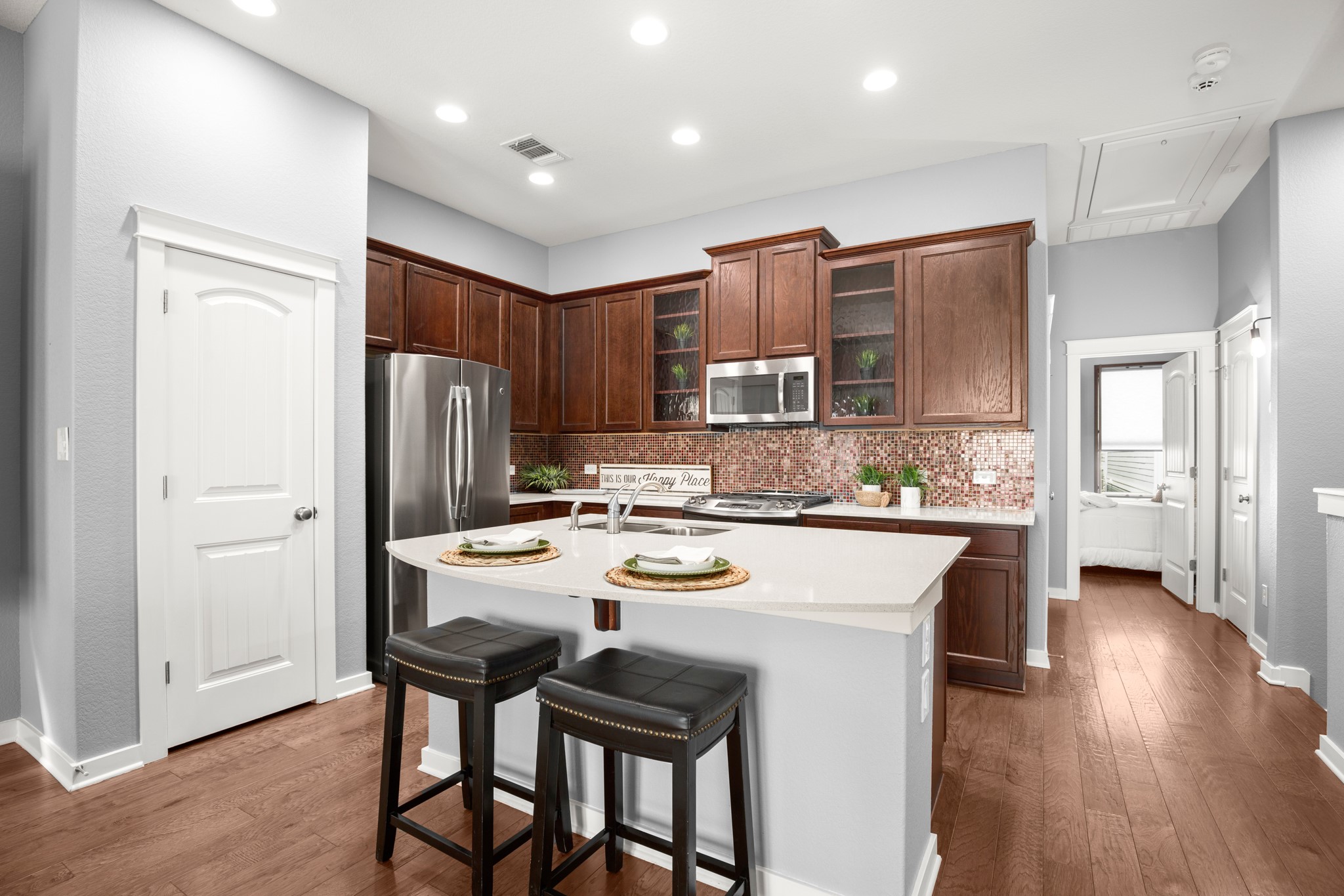4644 Page Street Austin, TX 78723 - Photo 6 of 21 a kitchen with stainless steel appliances a dining table chairs refrigerator and cabinets