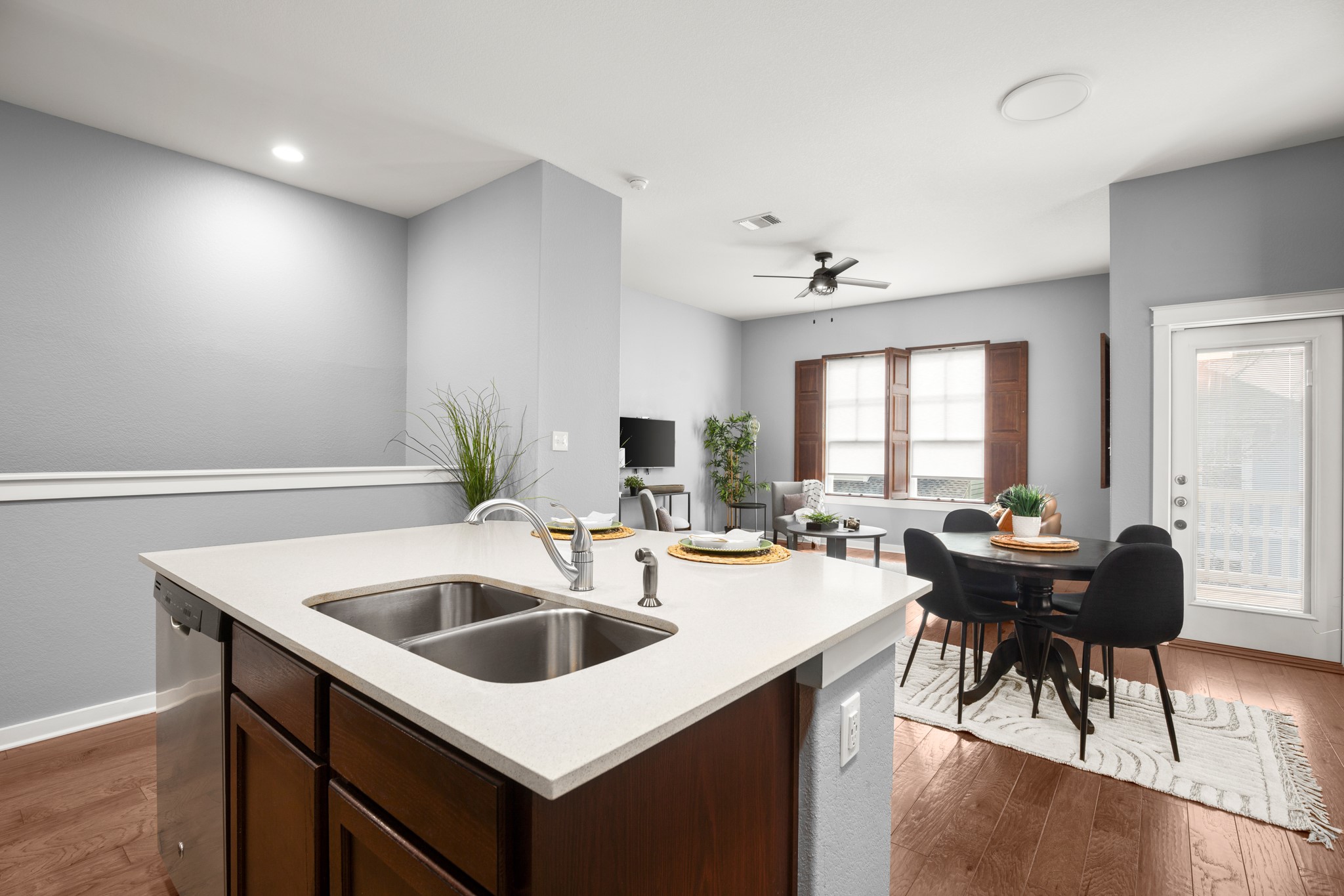 4644 Page Street Austin, TX 78723 - Photo 7 of 21 a kitchen with a sink a stove and chairs with wooden floor