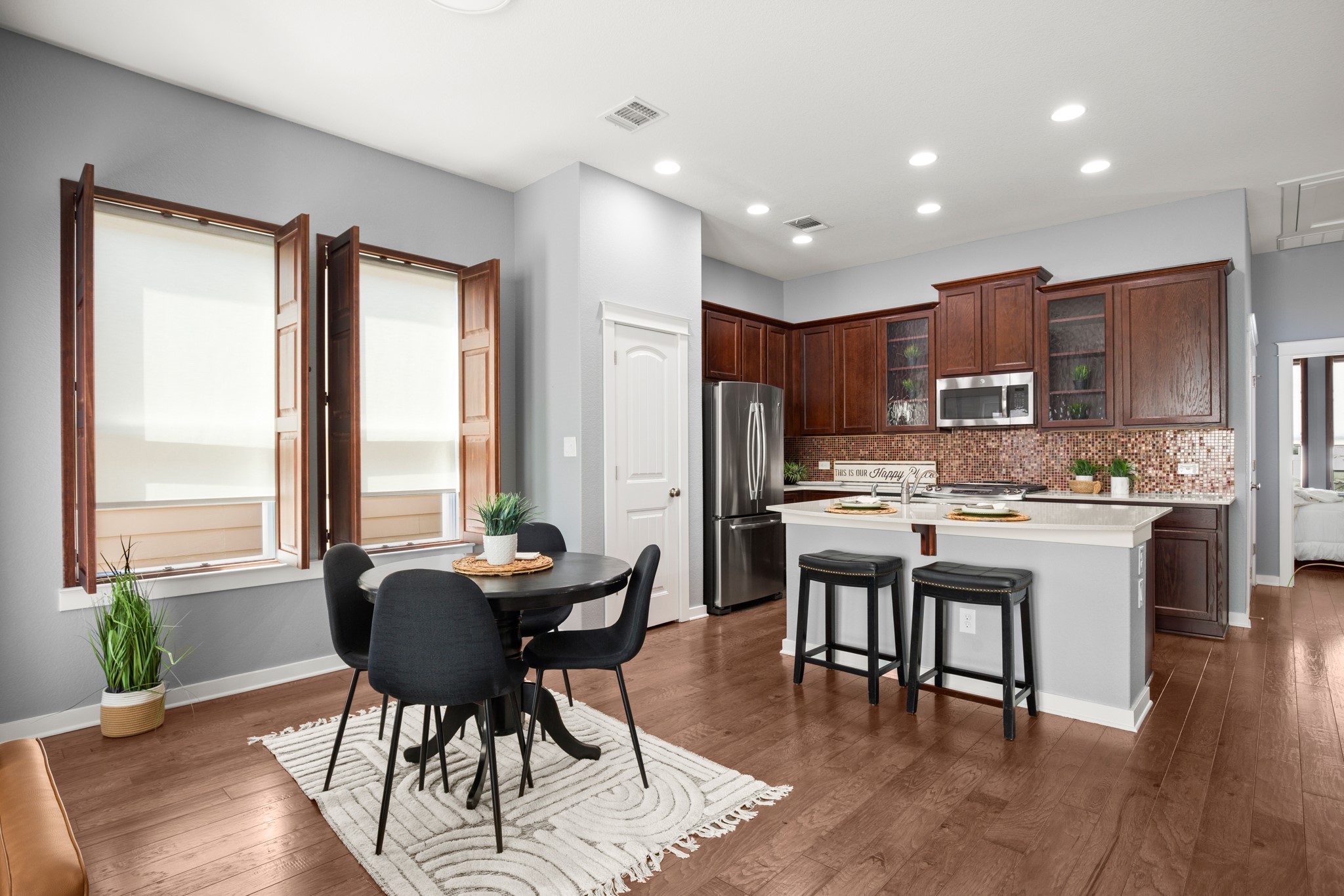 4644 Page Street Austin, TX 78723 - Photo 10 of 21 a dining room with stainless steel appliances kitchen island granite countertop furniture and a large window