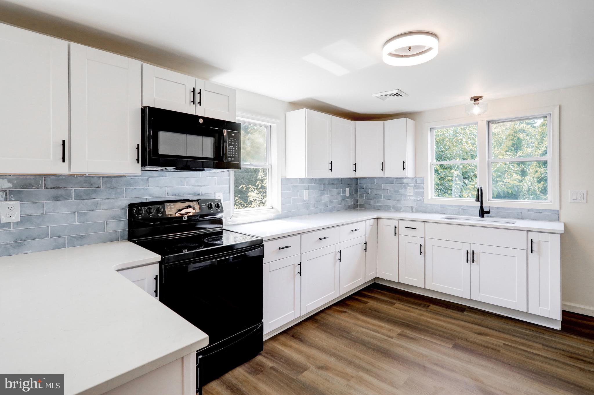 2145 Dunks Ferry Road Bensalem, PA 19020 - Photo 8 of 37 a kitchen with a sink stove and microwave
