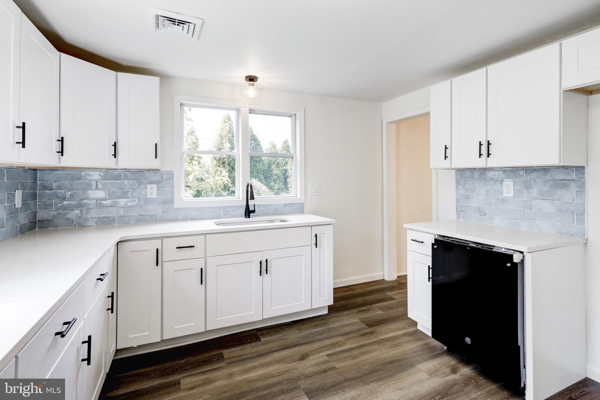 2145 Dunks Ferry Road Bensalem, PA 19020 - Photo 9 of 37 a kitchen with white cabinets and a sink