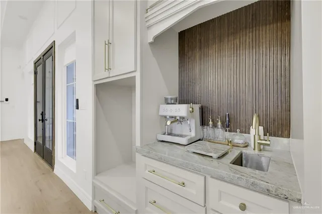 a bathroom with a granite countertop white and white cabinets