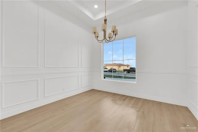 a view of a room with wooden floor and window
