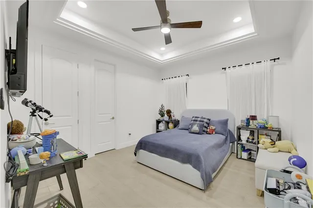 a bedroom with a bed furniture and a flat screen tv